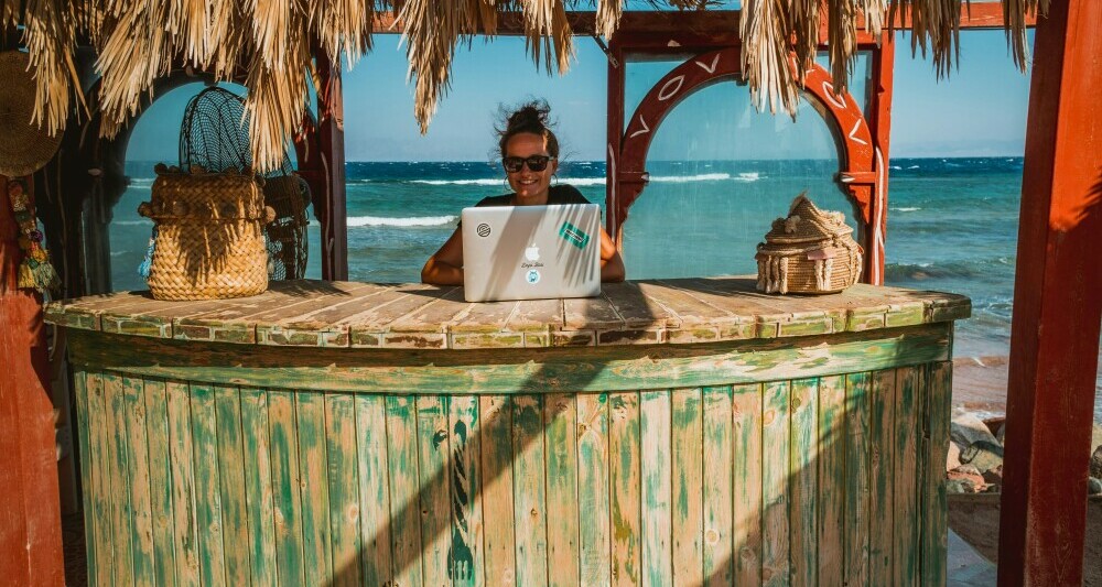 Digital nomad doing remote work on the beach